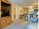 Cozy living room with entertainment center, bar seating, and adjacent dining area at 191 Maison Dr. # B-123, Myrtle Beach, SC 29572