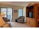 Comfortable living room features a plush sofa, patterned armchair, and a wooden entertainment center at 191 Maison Dr. # B-123, Myrtle Beach, SC 29572