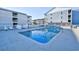 Community outdoor pool with lounge chairs with residential units in the background at 191 Maison Dr. # B-123, Myrtle Beach, SC 29572