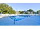 Outdoor pool area surrounded by lounge chairs, umbrellas, and a white picket fence at 191 Maison Dr. # B-123, Myrtle Beach, SC 29572