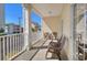 Inviting balcony with seating, white columns, and views of the neighborhood at 200 53Rd Ave. N # 209, North Myrtle Beach, SC 29582