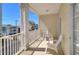 Relaxing balcony with white chairs and a view of the neighborhood at 200 53Rd Ave. N # 209, North Myrtle Beach, SC 29582