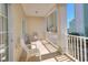Private balcony with white railings, seating, and a view of nearby buildings at 200 53Rd Ave. N # 209, North Myrtle Beach, SC 29582