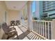 Serene balcony with seating, white railings, and views of surrounding buildings and greenery at 200 53Rd Ave. N # 209, North Myrtle Beach, SC 29582