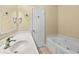 Bathroom featuring white vanities, soaking tub, and neutral-toned tile flooring at 200 53Rd Ave. N # 209, North Myrtle Beach, SC 29582