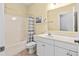 Bright bathroom features a vanity with white cabinetry, a sink, and a shower-tub combo with striped curtain at 200 53Rd Ave. N # 209, North Myrtle Beach, SC 29582