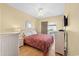 Relaxing bedroom boasts a woven-style bed, floral bedding, and a private balcony for enjoying the outdoors at 200 53Rd Ave. N # 209, North Myrtle Beach, SC 29582