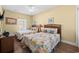 Charming bedroom features two beds with patterned quilts, wicker headboards, a ceiling fan and neutral walls at 200 53Rd Ave. N # 209, North Myrtle Beach, SC 29582