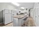 Bright kitchen with granite countertops, an island with seating, and stainless steel appliances at 200 53Rd Ave. N # 209, North Myrtle Beach, SC 29582