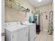 Bright laundry room featuring new washer and dryer, tile flooring, and plenty of storage space at 200 53Rd Ave. N # 209, North Myrtle Beach, SC 29582