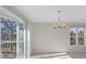 A dining room with a sliding glass door to a balcony offering views of trees and natural light at 2005 Havens Dr., North Myrtle Beach, SC 29582