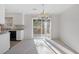 A dining room with access to a balcony with wooded views and white cabinets at 2005 Havens Dr., North Myrtle Beach, SC 29582