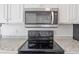The kitchen features a stainless steel microwave and a black smooth-top electric range at 2005 Havens Dr., North Myrtle Beach, SC 29582