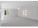 Spacious living room featuring neutral carpet and multiple windows for plenty of natural light at 2005 Havens Dr., North Myrtle Beach, SC 29582