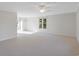 Bright living room with neutral carpet, ceiling fan, and large window for ample natural light at 2005 Havens Dr., North Myrtle Beach, SC 29582