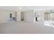 Open-concept living room with a deck, a kitchen, and neutral carpet at 2005 Havens Dr., North Myrtle Beach, SC 29582
