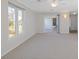 Bright living room with neutral carpet, large windows, and a sliding door to a private deck at 2005 Havens Dr., North Myrtle Beach, SC 29582