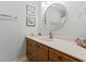 Bathroom vanity with framed mirror, wood cabinets, and a white countertop adorned with decorative seashell accents at 207 Double Eagle Dr. # F-3, Myrtle Beach, SC 29575