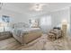 Bedroom features a wicker chair, wood-look floors, and neutral paint and furnishings at 207 Double Eagle Dr. # F-3, Myrtle Beach, SC 29575