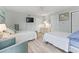 Bedroom featuring neutral paint, wood-look floors, and two queen beds at 207 Double Eagle Dr. # F-3, Myrtle Beach, SC 29575