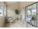 Cozy screened-in porch with comfortable seating, neutral tones, and a sliding door to a bright outdoor space at 207 Double Eagle Dr. # F-3, Myrtle Beach, SC 29575