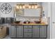 Stylish bathroom featuring a double vanity with vessel sinks, wood countertop, decorative mirror, and attractive lighting at 2191 Deerfield Ave., Surfside Beach, SC 29575