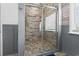 This bathroom features a spacious glass-enclosed shower with stylish tile work, and tasteful gray wall accents at 2191 Deerfield Ave., Surfside Beach, SC 29575