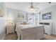 Bright bedroom features a whitewashed bed, coastal decor, tiled floor, and plenty of natural light at 2191 Deerfield Ave., Surfside Beach, SC 29575
