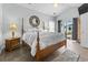 Bedroom featuring a four-poster bed, neutral walls, and a sliding glass door to the backyard at 2191 Deerfield Ave., Surfside Beach, SC 29575