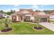 Charming single-story home featuring a lush lawn, mature palms, and a welcoming red front door at 2191 Deerfield Ave., Surfside Beach, SC 29575