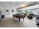 Finished garage space features a pool table and a clear garage door for plenty of natural light at 2191 Deerfield Ave., Surfside Beach, SC 29575
