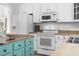 Kitchen featuring white appliances, wood countertops, and an island with built in drawer space at 2191 Deerfield Ave., Surfside Beach, SC 29575