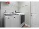Functional laundry room with modern washer, dryer, and storage shelves at 2191 Deerfield Ave., Surfside Beach, SC 29575