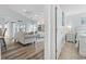 Bright living room next to bedroom with fan, light blue walls, built-in shelves, and wood-look floors at 2191 Deerfield Ave., Surfside Beach, SC 29575