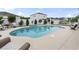 Inviting backyard pool with a charming waterfall feature, surrounded by stylish patio furniture and a privacy fence at 2191 Deerfield Ave., Surfside Beach, SC 29575