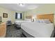 Bright bedroom featuring two beds, blue accents, and modern amenities for a comfortable stay at 2201 South Ocean Blvd. # 1808, Myrtle Beach, SC 29577