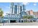Beautiful exterior view of a modern building with a parking garage and palm trees in front at 2201 South Ocean Blvd. # 1808, Myrtle Beach, SC 29577