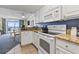 Well-appointed kitchen with white cabinetry and appliances, granite counters and ocean view at 2201 South Ocean Blvd. # 1808, Myrtle Beach, SC 29577