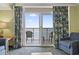 Enjoy a relaxing living room with a balcony, comfy seating, and ocean views through the windows at 2201 South Ocean Blvd. # 1808, Myrtle Beach, SC 29577
