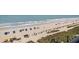 Elevated beach view showcasing the sandy shore, clear ocean, and colorful umbrellas dotting the landscape at 2311 South Ocean Blvd. # 559, Myrtle Beach, SC 29577