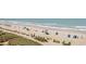 Expansive beach view with sunbathers, umbrellas, and gentle waves rolling in, perfect for a relaxing day at 2311 South Ocean Blvd. # 559, Myrtle Beach, SC 29577
