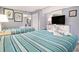Tastefully decorated bedroom with two beds, decorative artwork, and a dresser with a television at 2311 South Ocean Blvd. # 559, Myrtle Beach, SC 29577