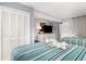 Well-furnished bedroom featuring two beds, a closet, a dresser, and a television for entertainment at 2311 South Ocean Blvd. # 559, Myrtle Beach, SC 29577