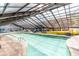 Spacious indoor pool with a clear glass roof, surrounded by tables and chairs for relaxation at 2311 South Ocean Blvd. # 559, Myrtle Beach, SC 29577