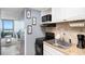 Cozy kitchen featuring an oven, microwave, and sink with granite-style countertops, plus distant ocean view at 2311 South Ocean Blvd. # 559, Myrtle Beach, SC 29577