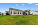 Large backyard featuring well-kept lawn, screened in porch, and back windows at 2317 Myerlee Dr., Myrtle Beach, SC 29588
