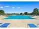 Large community swimming pool with blue lounge chairs and umbrellas at 2317 Myerlee Dr., Myrtle Beach, SC 29588