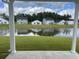 Tranquil view of the backyard pond showcasing manicured lawn and neighborhood homes at 240 Wagner Cir., Conway, SC 29526