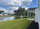 Scenic view of the backyard pond with water fountain, green grass, and nearby homes at 240 Wagner Cir., Conway, SC 29526