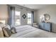 Relaxing bedroom with natural light, a comfortable bed, and a blue accent cabinet at 240 Wagner Cir., Conway, SC 29526